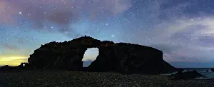 Canary Prints: Silhouette of majestic natural stone arch Arco del Jurado under a starry night sky