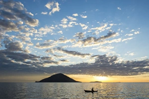 Malawi Prints: Silhouette of a man in a little fishing boat at sunset, Cape Malcear, Lake Malawi