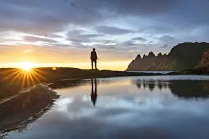 Adults Prints: Silhouette of man standing on rocks watching the mountain peaks at sunset