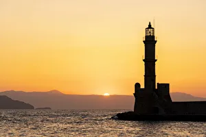 Chania Prints: Silhouette of the old lighthouse at sunset, Chania, Crete, Greek Islands, Greece, Europe