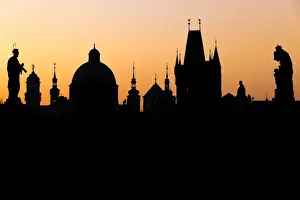 Bohemia Prints: Silhouette of the old town buildings seen from Charles Bridge at sunrise, UNESCO World