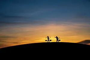 Outdoor Activity Prints: Silhouette of two people carrying baskets at sunset
