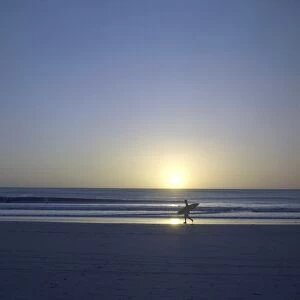 Costa Rica Gallery: Silhouette of surfer walking on Avellanas Beach, Nicoya Peninsula, Costa Rica