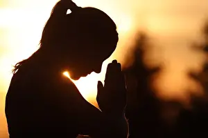 Yoga Prints: Silhouette of a woman practising yoga against the light of the evening sun, French Alps