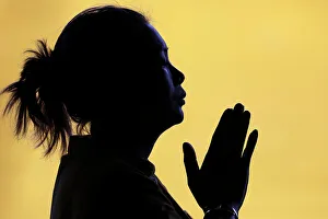 Back Lit Prints: Silhouette of woman praying in temple