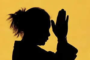 Back Lit Prints: Silhouette of woman praying in temple Faith and spirituality concept