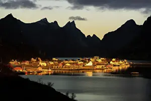 Lofoten Islands Prints: Silhouettes of mountains framing the fairy tale village along the fjord at dawn