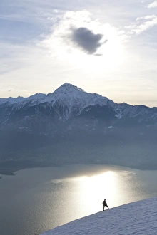 Silhoutte of a hiker facing Mount Legnone and Lake Como at sunset, Lombardy, Italy, Europe Silhoutte of a hiker facing Mount Legnone and Lake Como at sunset, Lombardy, Italy, Europe