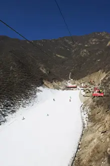 A ski lift taking skiers up to the slopes at Shijinglong ski resort, Beijing, China, Asia