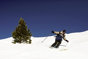 Images Dated 7th January 2008: A skier carves a long turn on a classic off piste run at the big French resort of Meribel in