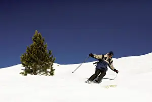 Carve Prints: A skier carves a long turn on a classic off piste run at the big French resort of Meribel in the Three Valleys