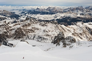 Skiers Prints: Skiers descend from the top of Marmolada in the Dolomites, Italy, Europe