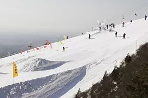 Skiers and snowboarders at Shijinglong ski resort, Beijing, China, Asia
