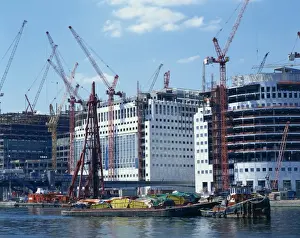 Docklands Prints: Skips on barges and cranes in front of buildings under construction in the Docklands