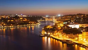 Connections Gallery: Skyline of the historic city of Porto at night with the bridge Ponte de Arrabida in the background