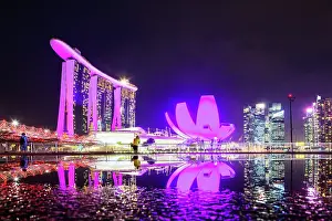 Innovation Prints: Skyline of Singapore Marina Bay at night with Marina Bay Sands and Art Science museum reflecting in a pond after rain