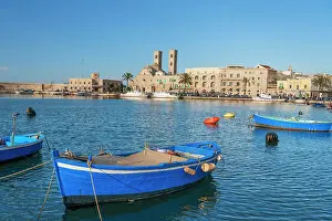 Small blue boats moored in the water of the harbour of the old medieval town of Barletta, Adriatic Sea, Mediterranean Sea, Apulia, Italy, Europe