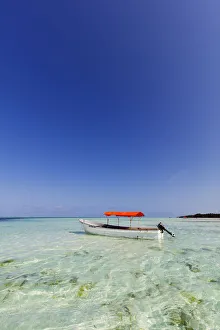 Small boat in crystal clear water, Pingwe, Island of Zanzibar, Tanzania, East Africa