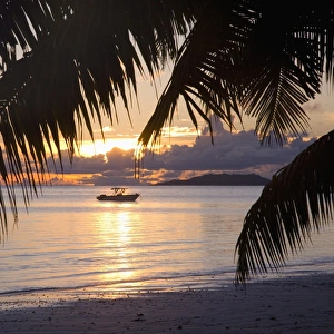 Images Dated 4th May 2009: Small boat moored off the beach at Anse Volbert at sunrise, Baie Sainte Anne district