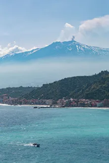 Typically Italian Gallery: Small boat passing the awe inspiring Mount Etna, UNESCO World Heritage Site