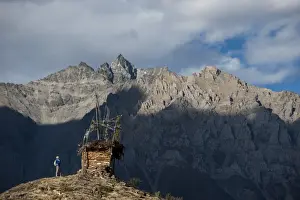 A small chorten strewn with prayer flags marks the top of a hill near Ringmo in