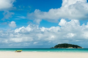 A small dinghy sits on the white sand of Whitehaven Beach, Whitsunday Island, Australia