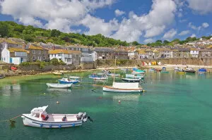 Small fishing boats in the enclosed harbour at Mousehole, Cornwall, England