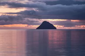 Silhouetted Gallery: The small island of Litla Dimun before sunrise, Faroe Islands, Denmark, Europe