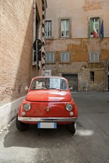 Flag Prints: Small old Fiat 500 car parked on a back street in Rome, Lazio, Italy, Europe