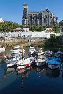 Aquitaine Prints: Small port with traditional fishing boats and Eglise Sainte Eugenie in Biarritz