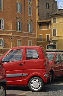 Outdors Prints: Small red car parked in square off Via Giulia