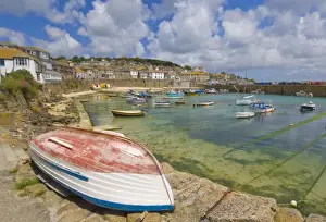Fishing Boats Prints: Small unturned boat on the quay and small boats in the enclosed harbour at Mousehole