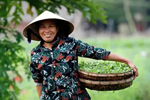 Adults Prints: Smiling Vietnamese woman wearing the traditional palm leaf conical hat, Hoi An, Vietnam