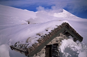 Drift Prints: Smoke from chimney as stove is fired up inside a buried stone hut