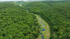 Flowing Prints: Snaking river winding through green landscape around an important historical site in France