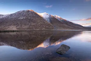 Snow capped Highlands mountains reflected in the calm waters of Loch Etive in winter