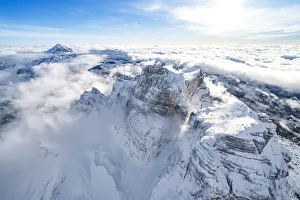 Monte Pelmo Prints: Snow capped Monte Pelmo emerging from clouds, aerial view, Dolomites, Belluno province
