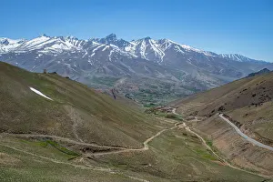 Season Prints: Snow-capped mountains and winding roads in a mountain pass near Bamiyan Afghanistan during clear weather