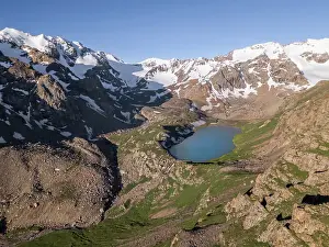 Nature Lovers Prints: Snow-capped peaks and Kol Tor Lake in a lush valley showcasing stunning landscape