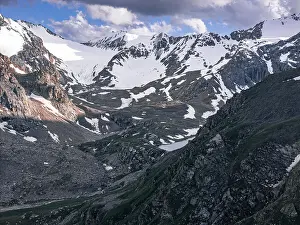 Hiking Trails Prints: Snow-capped peaks and lush valleys at sunset showcased in a stunning landscape