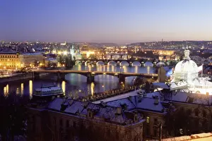Mala Strana Prints: Snow covered bridges across Vltava River dividing Old Town from Mala Strana suburbs in winter twilight