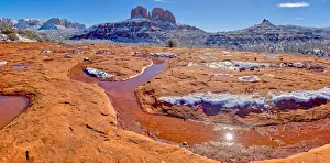 Snow covered Cathedral Rock in Sedona viewed from a sandstone plateau along Secret Slick