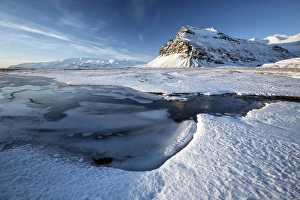 South Iceland Prints: Snow covered landscape in winter with frozen pool, mountain and Vatnajokull Glacier