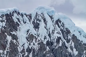 Fjord Prints: Snow-covered mountains rise in Crystal Sound located south of the Antarctic Circle in Antarctica