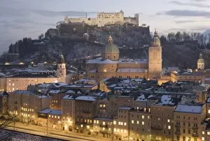 Snow covered Old Town with towers of Glockenspiel, Dom and Franziskanerkirche churches dominated by the fortress of