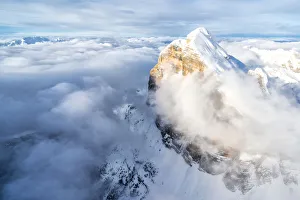 Belluno Province Prints: Snow covered Tofana di Rozes above the clouds, aerial view, Dolomites, Belluno province