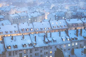Hesse Prints: Snow falling over the traditional houses of the old town at dusk