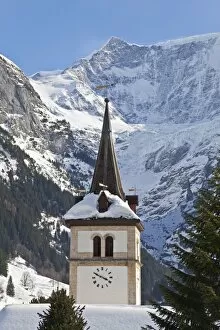 Snow and ice covered mountains above the village church in Grindelwald