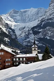 Grindelwald Prints: Snow and ice covered mountains above the village church in Grindelwald