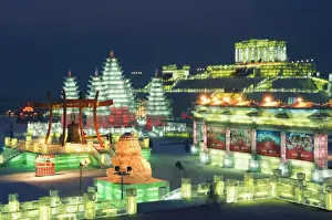 Snow and ice sculptures illuminated at night at the Ice Lantern Festival